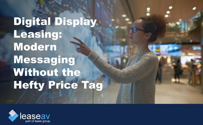 Image of woman touching interactive digital display screen to illustrate the benefits of digital display leasing