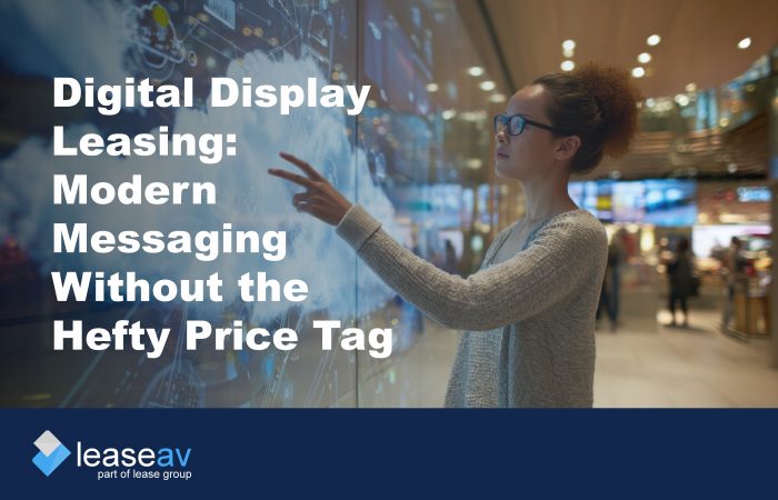 Image of woman touching interactive digital display screen to illustrate the benefits of digital display leasing