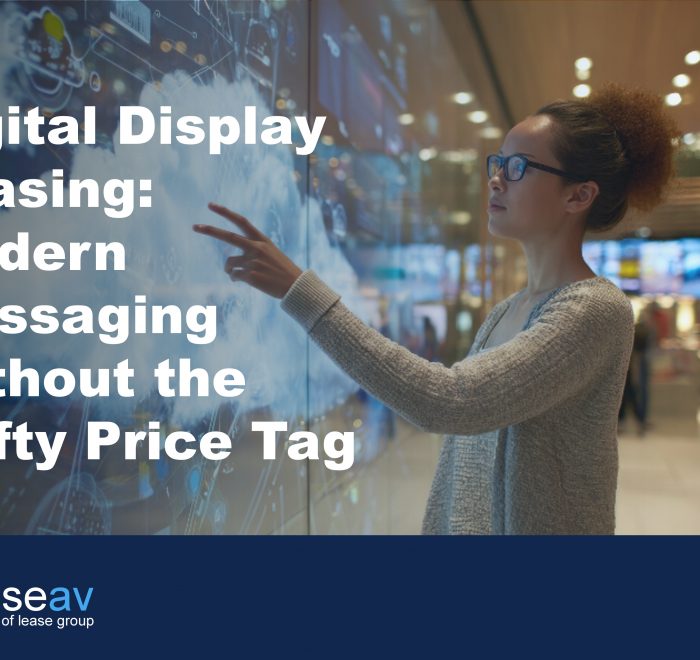 Image of woman touching interactive digital display screen to illustrate the benefits of digital display leasing